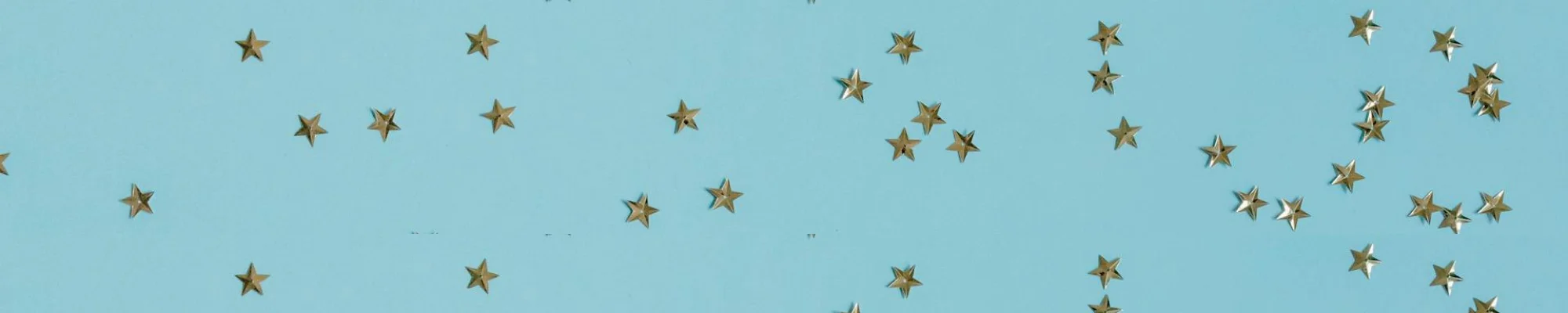 Gold confetti stars on a light blue background