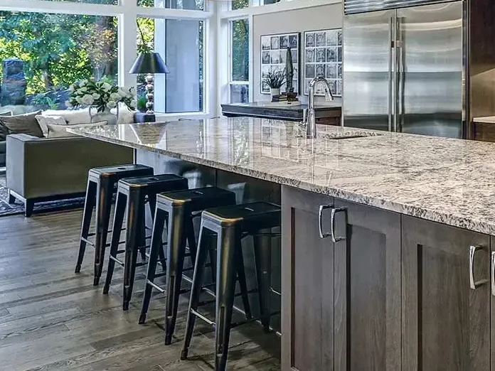 Grey kitchen cabinets with marble counters